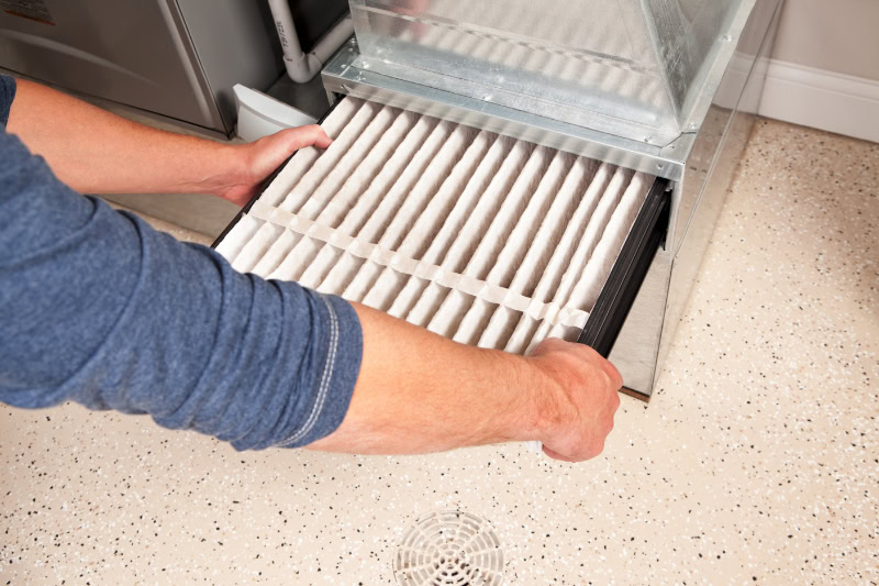 A tech replacing a filter.